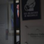 
              A portrait of lawmaker Guillermo Gallegos is seen through a window in his office, on Monday, May 16, 2022, in San Salvador, El Salvador. Lawmakers voted last year to uphold the country’s abortion ban, one of the world’s strictest, with some citing Scripture. Gallegos is outwardly against abortion, saying that it goes against his Christian faith. (AP Photo/Jessie Wardarski)
            