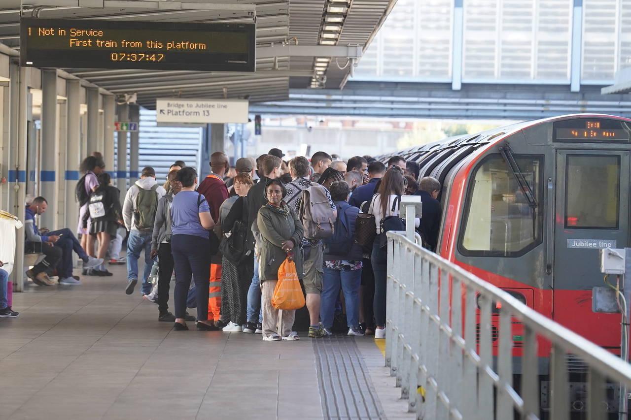 Passengers board a tube at Stratford station, as train services continue to be disrupted following ...
