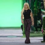 
              Designer Donatella Versace accepts applause at the end of the Versace men's Spring Summer 2023 collection presented in Milan, Italy, Saturday, June 18, 2022. (AP Photo/Luca Bruno)
            