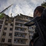 
              Servicemen work at the scene at a residential building following explosions, in Kyiv, Ukraine, Sunday, June 26, 2022. Several explosions rocked the west of the Ukrainian capital in the early hours of Sunday morning, with at least two residential buildings struck, according to Kyiv mayor Vitali Klitschko. (AP Photo/Nariman El-Mofty)
            