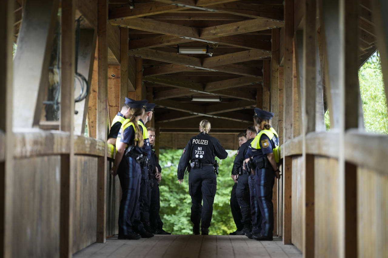 Police officers stand guard on a bridge near a protest camp against the G7 Summit in Garmisch-Parte...