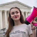 
              Grace Rykaczewski, 21, of Morristown, N.J., poses for a portrait as she demonstrates against abortion, Saturday, May 14, 2022, outside the Supreme Court in Washington. “Once it’s overturned, for the pro-life movement this is only the beginning,” said Rykaczewski, who calls herself a, “Pro Life Barbie,” on social media. (AP Photo/Jacquelyn Martin)
            