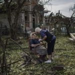 
              Elena Holovko sits among debris outside her house damaged after a missile strike in Druzhkivka, eastern Ukraine, Sunday, June 5, 2022. (AP Photo/Bernat Armangue)
            