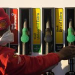 
              A petrol pump attendant replaces a pump at a filling station in Soweto, South Africa, Tuesday, May 31, 2022. South Africans are feeling the bite of fuel price increases that are blamed on Russia's war in Ukraine and the rise in the Brent crude oil price. (AP Photo/Themba Hadebe)
            