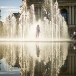 
              A young girl runs in a public fountain in front of the Opera house in Lviv, Ukraine, Thursday, June 2, 2022. (AP Photo/Francisco Seco)
            