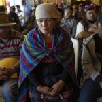 
              Magdalena Tepaz, center, and Manuel de Jesus Tulul, right, parents of Wilmer Tulul, wait for the start of a community meeting in Tzucubal, Guatemala, Wednesday, June 29, 2022. Wilmer and his cousin Pascual, both 13, were among the many dead discovered inside a tractor-trailer on the edge of San Antonio, Texas, on Monday. (AP Photo/Moises Castillo)
            