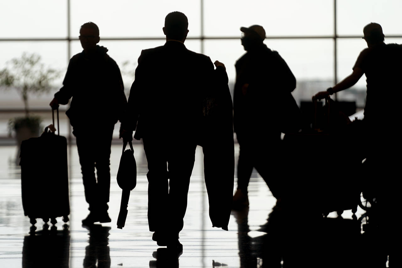 Travelers are shown at Salt Lake City International Airport Monday, June 13, 2022, in Salt Lake Cit...