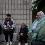 
              A woman waits in line for social help in Makariv, on the outskirts of Kyiv, Ukraine, Tuesday, June 14, 2022. (AP Photo/Natacha Pisarenko)
            