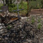 
              A cross marks the grave of a local resident buried in a courtyard in a village near the frontline in the Donetsk oblast region, eastern Ukraine, Thursday, June 2, 2022. (AP Photo/Bernat Armangue)
            