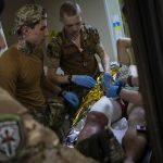
              Paramedics treat a Ukrainian injured serviceman in the Donetsk region, eastern Ukraine, Tuesday, June 7, 2022. (AP Photo/Bernat Armangue)
            