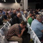 Attendees pray during a worship service at the Southern Baptist Convention's annual meeting in Anaheim, Calif., Tuesday, June 14, 2022. (AP Photo/Jae C. Hong)