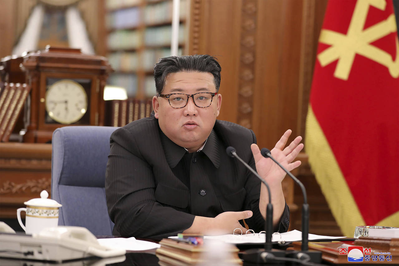 In this photo provided by the North Korean government, North Korean leader Kim Jong Un attends a me...