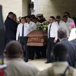 
              Pallbearers carry a casket following a joint funeral service for Irma Garcia and husband Joe Garcia at Sacred Heart Catholic Church, Wednesday, June 1, 2022, in Uvalde, Texas. Irma Garcia was killed in last week's elementary school shooting; Joe Garcia died two days later. (AP Photo/Eric Gay)
            
