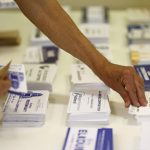 
              A voter picks up ballots at a voting station in Strasbourg, eastern France, Sunday June 12, 2022. Sunday, June 12, 2022. French voters are choosing lawmakers in a parliamentary election as President Emmanuel Macron seeks to secure his majority while under growing threat from a leftist coalition. (AP Photo/Jean-Francois Badias)
            