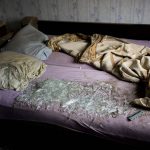 
              Shattered glass lies on the bed at a house damaged after a strike in Druzhkivka, Ukraine, Sunday, June 5, 2022. (AP Photo/Bernat Armangue)
            