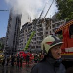 
              Firefighters work at the scene of a residential building following explosions, in Kyiv, Ukraine, Sunday, June 26, 2022. Several explosions rocked the west of the Ukrainian capital in the early hours of Sunday morning, with at least two residential buildings struck, according to Kyiv mayor Vitali Klitschko. (AP Photo/Nariman El-Mofty)
            
