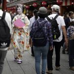 
              A Geisha woman in traditional Japanese "kimono" walks along a shopping street at the Asakusa district Friday, June 10, 2022, in Tokyo. Japan on Friday eased its borders for foreign tourists and began accepting applications, but only for those on guided package tours who are willing to follow mask-wearing and other antivirus measures as the country cautiously tries to balance business and infection worries. (AP Photo/Eugene Hoshiko)
            