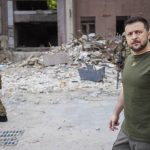 
              In this photo provided by the Ukrainian Presidential Press Office on Saturday, June 18, 2022, Ukrainian President Volodymyr Zelenskyy inspects damaged buildings as he visits the war-hit Mykolaiv region. (Ukrainian Presidential Press Office via AP)
            