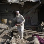 
              A man salvages belongings from his destroyed house after an earthquake in Gayan district in Paktika province, Afghanistan, Sunday, June 26, 2022. A powerful earthquake struck a rugged, mountainous region of eastern Afghanistan early Wednesday, flattening stone and mud-brick homes in the country's deadliest quake in two decades, the state-run news agency reported. (AP Photo/Ebrahim Nooroozi)
            