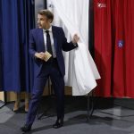 
              France's President Emmanuel Macron leaves the voting booth before voting in the first round of French parliamentary election at a polling station in Le Touquet, northern France, Sunday June 12, 2022. French voters are choosing lawmakers in a parliamentary election Sunday as President Emmanuel Macron seeks to secure his majority while under growing threat from a leftist coalition. (Ludovic Marin, Pool via AP)
            
