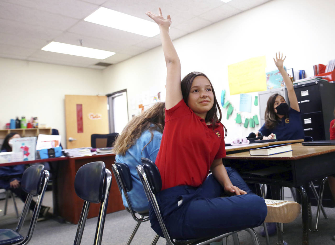 Lilianna Naizer-Baldwin,10, foreground center, raises her hand during her Spanish class at the New ...
