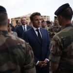 
              French President Emmanuel Macron greets French soldiers at the Mihail Kogalniceanu Air Base, near the city of Constanta, Romania, Tuesday, June 14, 2022. French President Emmanuel Macron travels to Romania where he is set to hold bilateral talks with officials and meet with French troops who are part of NATO's response to Russia's invasion of Ukraine. France has around 500 soldiers deployed in Romania and has been a key player in NATO's bolstering of forces on the alliance's eastern flank following Russia's invasion on Feb. 24. (Yoan Valat, Pool via AP)
            