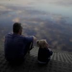 
              A man sits with a child at Natalka Park in Kyiv, Ukraine, Tuesday, June 7, 2022. (AP Photo/Natacha Pisarenko)
            