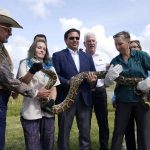 
              Florida Gov. Ron DeSantis, center, holds a Burmese python at a media event, Thursday, June 16, 2022, where he announced that registration for the 2022 Florida Python Challenge has opened for the annual 10-day event to be held Aug 5-14, , in Miami. The Python Challenge is intended to engage the public in participating in Everglades conservation through invasive species removal of the Burmese python. Also pictured are Ron Bergeron, left, McKayla Spencer, second from left, Rodney Barreto, third from right, and Jan Fore, second from right. (AP Photo/Lynne Sladky)
            