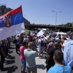 
              Dozens of workers from the factory in Serbia of Fiat Stellantis Automobiles company block a key bridge and motorway during a protest in Belgrade, Serbia, Wednesday, June 22, 2022. The workers traveled from the central town of Kragujevac, where the factory is located, to Belgrade, saying they wanted to press for their demands for better severance deals for the factory employees who are to lose jobs or get transferred to other factories in Europe. (AP Photo/Darko Vojinovic)
            