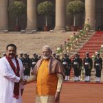
              FILE - Indian Prime Minister Narender Modi, right, shakes hand with his then Sri Lankan counterpart Mahinda Rajapaksa, during a ceremonial reception for Rajapaksa at the Indian presidential palace, in New Delhi, India, Saturday, Feb. 8, 2020. Sri Lanka's strategic location has attracted outsized interest in the small island nation from regional giants China and India for more than a decade, with Beijing and its free-flowing loans and infrastructure investments widely seen as having gained the upper hand in the quest for influence. (AP Photo/Manish Swarup, File)
            