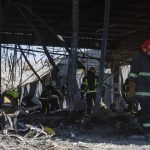 
              Ukrainian State Emergency Service firefighters work to take away debris at a shopping center burned after a rocket attack in Kremenchuk, Ukraine, Tuesday, June 28, 2022. (AP Photo/Efrem Lukatsky)
            