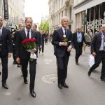 
              Norway's Crown Prince Haakon, center left, and Prime Minister Jonas Gahr Stoere, center right, visit the scene of a shooting in central Oslo, Norway, Saturday, June 25, 2022. Norwegian police say they are investigating an overnight shooting in Oslo that killed two people and injured more than a dozen as a case of possible terrorism. In a news conference Saturday, police officials said the man arrested after the shooting was a Norwegian citizen of Iranian origin who was previously known to police but not for major crimes. (Javad Parsa/NTB via AP)
            