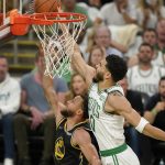 
              Boston Celtics forward Jayson Tatum (0) attempts to block a shot by Golden State Warriors guard Stephen Curry (30) during the first quarter of Game 4 of basketball's NBA Finals, Friday, June 10, 2022, in Boston. (AP Photo/Steven Senne)
            