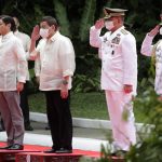 
              Incoming Philippine president Ferdinand Marcos Jr., left, and outgoing President Rodrigo Duterte, second left, salute during Marcos' inauguration ceremony at the Malacanang Presidential Palace grounds in Manila, Philippines, Thursday, June 30, 2022. Marcos, the son of the late president Ferdinand Marcos has been sworn in as the Philippine president. (Francis R. Malasig/Pool Photo via AP)
            