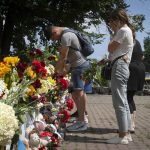 
              People lay flowers to pay the last respect to victims of the Russian rocket attack at a shopping center in Kremenchuk, Ukraine, Wednesday, June 29, 2022. (AP Photo/Efrem Lukatsky)
            