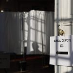 
              A person is shadowed on a voting booth in a polling station Sunday, June 19, 2022 in Bischeim, outside Strasbourg, eastern France. French voters are going to the polls in the final round of key parliamentary elections that will demonstrate how much legroom President Emmanuel Macron's party will be given to implement his ambitious domestic agenda. (AP Photo/Jean-Francois Badias)
            