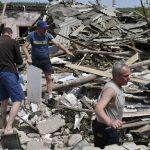 
              People clean an area of a building damaged by an overnight missile strike in Sloviansk, Ukraine, Wednesday, June 1, 2022. (AP Photo/Andriy Andriyenko)
            