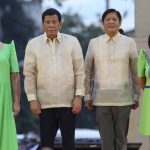 
              FILE - Outgoing Philippine President Rodrigo Duterte, second from left, stands beside incoming Philippine President Ferdinand "Bongbong" Marcos Jr., second from right, as they attend the oath taking rites of Vice-President elect Sara Duterte in Davao city, southern Philippines on June 19, 2022. Ferdinand Marcos Jr., the namesake son of an ousted dictator, is to be sworn in as Philippine president Thursday, June 30, in one of the greatest political comebacks in recent history but which opponents say was pulled off by whitewashing his family’s image. (AP Photo/Manman Dejeto, File)
            