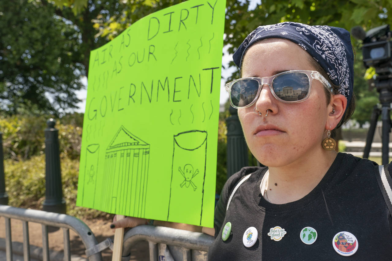 Erin Tinerella, of Chicago, who is in Washington for the summer at an internship, protests against ...