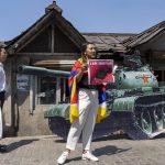 
              A young exile Tibetan stands in front of a cardboard cutout of a tank to replicate the 'tank man', an iconic moment in the Tiananmen Square pro-democracy protests in 1989, in Dharmsala, India, Saturday, June 4, 2022. Saturday marks the anniversary of China’s bloody 1989 crackdown on pro-democracy protests at Beijing’s Tiananmen Square. (AP Photo/Ashwini Bhatia)
            