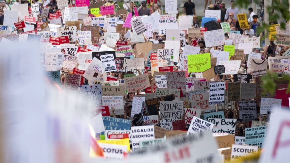 FILE - People march through Downtown Atlanta on June 24, 2022, to protest the Supreme Court's decis...