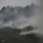
              Smoke rises from at a forest fire near Louchats, 35 kms (22 miles) from Landiras in Gironde, southwestern France, Monday, July 18, 2022. France scrambled more water-bombing planes and hundreds more firefighters to combat spreading wildfires that were being fed Monday by hot swirling winds from a searing heat wave broiling much of Europe. With winds changing direction, authorities in southwestern France announced plans to evacuate more towns and move out 3,500 people at risk of finding themselves in the path of the raging flames. (Phillippe Lopez)
            