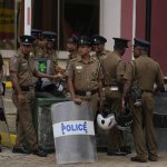 
              Police officers stand guard outside the official residence of the president in Colombo, Sri Lanka, Thursday, July 21, 2022. Sri Lanka's prime minister Ranil Wickremesinghe was elected president Wednesday by lawmakers who opted for a seasoned, veteran leader to lead the country out of economic collapse, despite widespread public opposition. (AP Photo/Rafiq Maqbool)
            