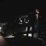 
              A Ukrainian police officer stops a man in his car to check documents, at a check point during night time curfew, in Donetsk region, eastern Ukraine, Friday, July 22, 2022. (AP Photo/Nariman El-Mofty)
            