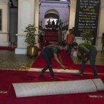 
              Protesters roll a carpet at the official residence of President Gotabaya Rajapaksa in in Colombo, Sri Lanka, Thursday, July 14, 2022. With the country sinking into political chaos, Rajapaksa and his wife fled to the Maldives on Wednesday aboard an air force jet. He made the prime minister acting president in his absence — a move that further roiled passions among a public that blames Rajapaksa for an economic crisis that has caused severe shortages of food and fuel. (AP Photo/Rafiq Maqbool)
            