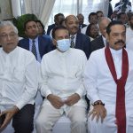 
              In this photo provided by Sri Lankan President's Office, lawmaker Lakshman Kiriella, left, former president Maithripala Sirisena, center and former prime minister Mahinda Rajapaksa, right attend the swearing in ceremony of  Sri Lanka's newly elected president Ranil Wickremesinghe, in Colombo, Sri Lanka, Thursday, July 21, 2022. (Sri Lankan President's Office via AP)
            