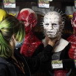 
              Jenn Brown of CFX (Composite Effects) adjusts a silicon mask based on Pinhead from the movie franchise "Hellraiser" in their stall during Preview Night at the 2022 Comic-Con International at the San Diego Convention Center, Wednesday, July 20, 2022, in San Diego. (AP Photo/Chris Pizzello)
            