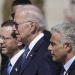 
              President Joe Biden, center, Israeli President Isaac Herzog, left, and Israeli Prime Minister Yair Lapid, walk during a welcoming ceremony after Biden arrived at Ben Gurion Airport, near Tel Aviv, Israel, Wednesday, July 13, 2022. Biden arrives in Israel on Wednesday for a three-day visit, his first as president. He will meet Israeli and Palestinian leaders before continuing on to Saudi Arabia. (AP Photo/Ariel Schalit)
            