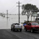 
              Residential properties and roads are submerged under floodwater from the swollen Hawkesbury River in Windsor, northwest of Sydney, Australia Monday, July 4, 2022. (Bianca De Marchi/AAP Image via AP)
            