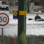 
              A man paddles his kayak through a flooded street at Windsor on the outskirts of Sydney, Australia, Tuesday, July 5, 2022. Hundreds of homes have been inundated in and around Australia's largest city in a flood emergency that was impacting 50,000 people, officials said Tuesday. (AP Photo/Mark Baker)
            